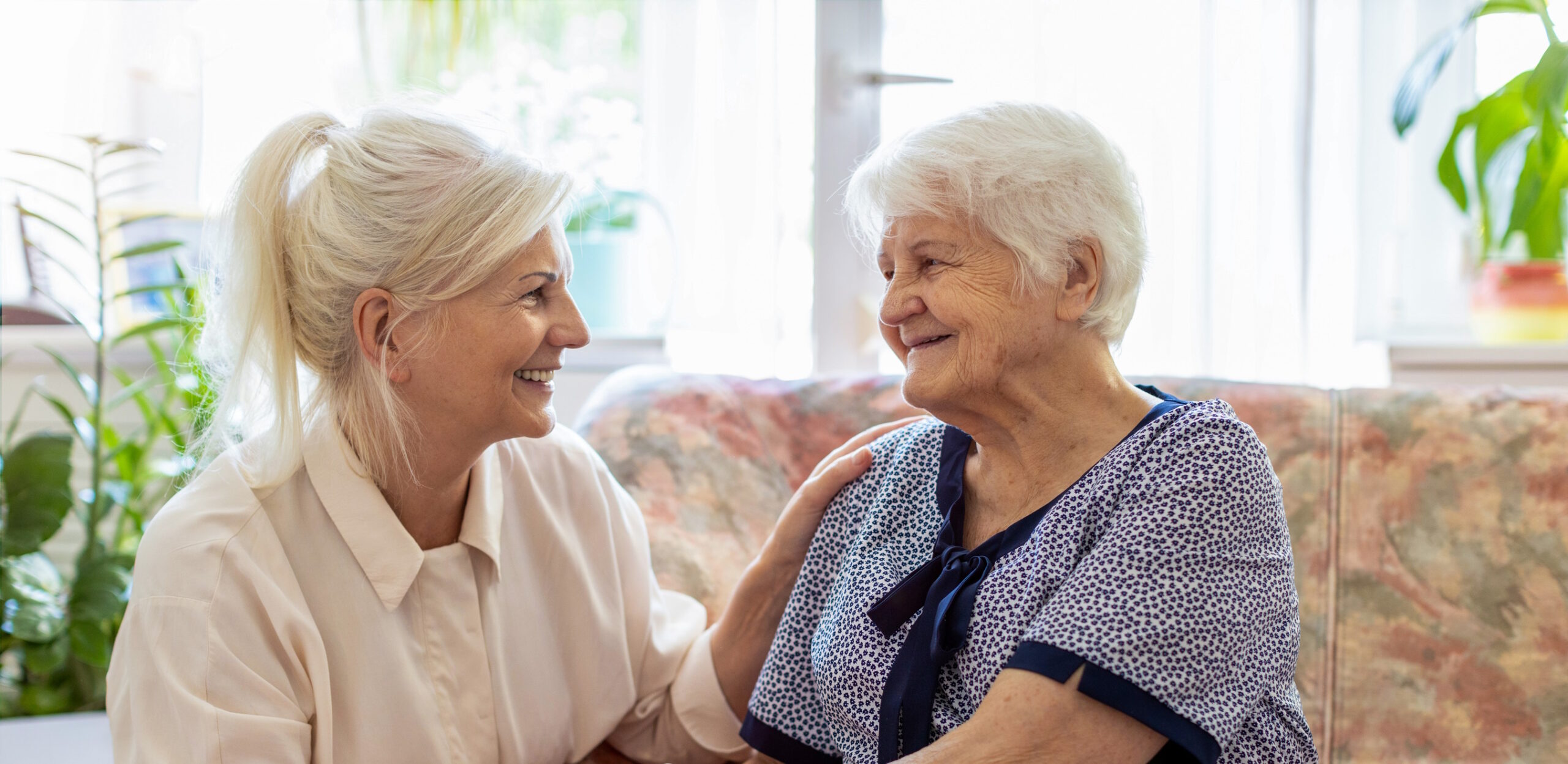 daughter talking to elderly mother