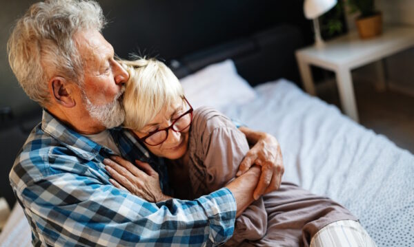 senior husband hugging wife