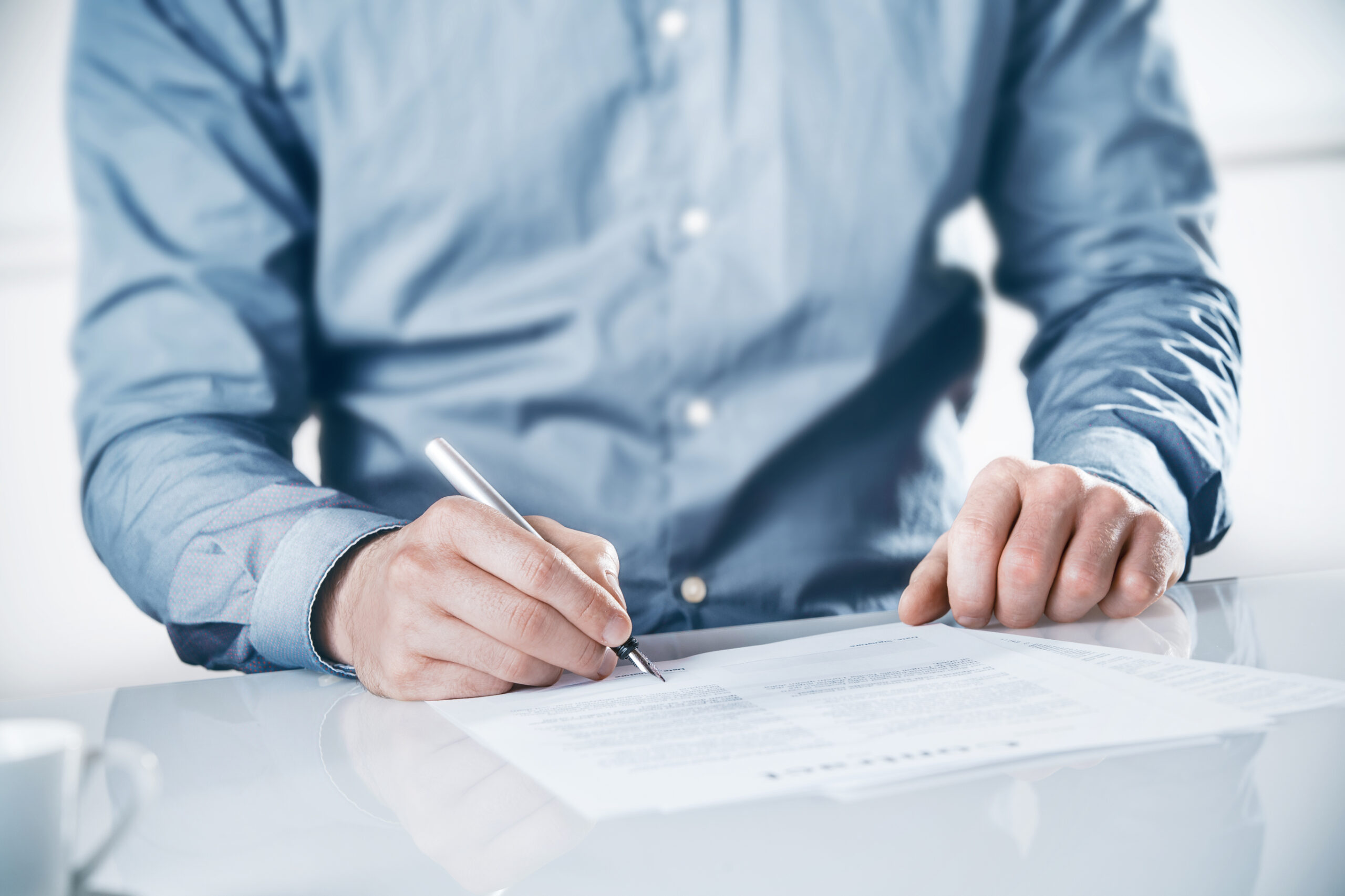 man signing document